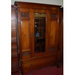 An Edwardian walnut single mirror door wardrobe with carved detail, width 132cm