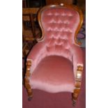 A mid-Victorian mahogany spoonback show frame armchair, having pink dralon buttoned upholstery,