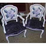 A pair of Louis XV style white painted and upholstered fauteuilles, each raised on cabriole