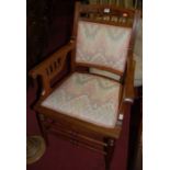 A late Victorian walnut and bright coloured floral needlework pad back and seat inset elbow chair,