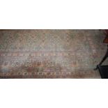 A large Persian cream ground woollen Tabriz carpet, having an all over floral stylised trailing