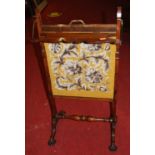 A Regency rosewood adjustable fire screen, having a fold-over top and embroidered panel on carved