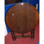 An early 20th century oval tilt-top folding occasional table, width 76cm