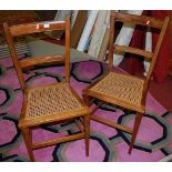 A pair of early 20th century beech and cane seat bedroom chairs