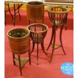 An Edwardian mahogany and boxwood strung jardiniere stand, having a typical bowl shaped top on