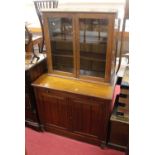 An Edwardian walnut double door side cupboard, w.94cm; together with an Edwardian oak double door