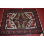 A small Persian woollen Shiraz rug, decorated with birds within a floral surround, 82 x 63cm