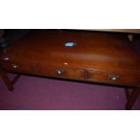 A contemporary campaign style mahogany and flush brass low three-drawer coffee table, w.137cm