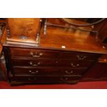 A George III mahogany chest of two short over three long graduated drawers, flanked by reeded