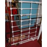 A Victorian style white painted wrought iron and brass double bedstead, with side rails and