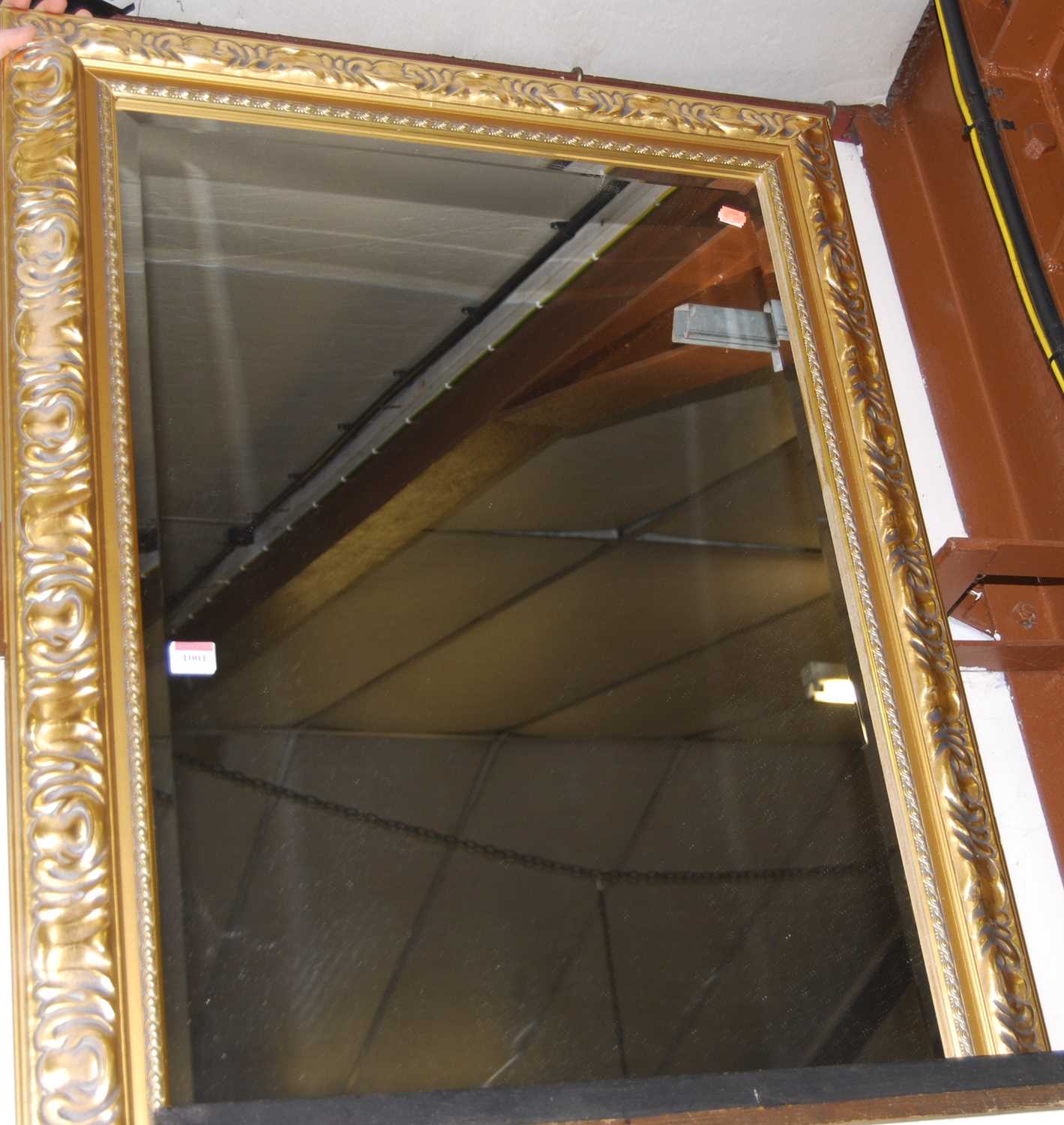 A modern gilt framed rectangular wall mirror