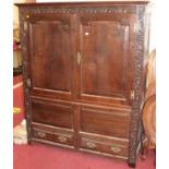 An 18th century and larer carved oak double door side cupboard, w.146cm