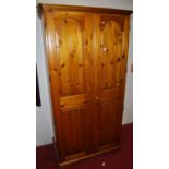 A late 20th century pine double door wardrobe, w.100cm