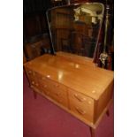 A 1970s walnut mirrorback dressing table, w.125cm