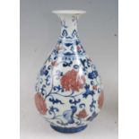 A Chinese export vase having a flared rim to a pear shaped bulbous lower body, decorated with