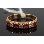 An 18ct gold, ruby and diamond half eternity ring, arranged as seven alternating round cut rubies