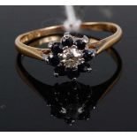 An 18ct gold, sapphire and diamond flower-head cluster ring, the centre brilliant cut diamond
