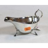 A George V silver sauceboat, of plain undecorated form, having C-scroll handle and hoof feet, 3.4oz