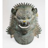 An eastern verdigris metal zoomorphic mask, 42cm high