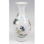 A Chinese Famille Verte vase having a flared rim to slender neck and bulbous lower body enamel
