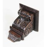 An early 20th century carved dark oak bracket, decorated with scrolls and acanthus leaves, height