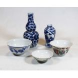 A Chinese export blue and white bowl, decorated with a bird perched upon a branch with flowers,