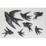 A collection of six continental carved softwood and painted figures of swallows, largest length