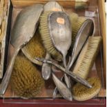 A collection of assorted silver backed dressing table brushes and mirrors