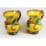 A pair of Art Deco Wade Heath yellow glazed jugs, relief decorated with birds, having printed mark