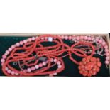 Five various coral necklaces, each being beaded, two with yellow metal dividers; together with a