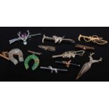 A collection of sporting related brooches, letter clip, tie clip etc