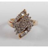 A 9ct yellow gold diamond marquise shaped cluster ring, featuring twenty-five round brilliant cut