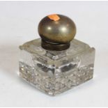 A large heavy cut glass inkwell, having silver domed cover