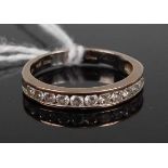 An 18ct white gold diamond half eternity ring, arranged as twelve channel small brilliants, 2.8g,