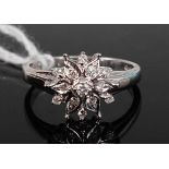 A contemporary 18ct white gold diamond flower-head cluster ring, arranged as thirteen small