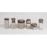 A collection of six late Victorian and later silver topped glass dressing table jars
