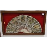 A cased bone handled fan, the printed areas depicting society scenes, case dimensions 34 x 58.