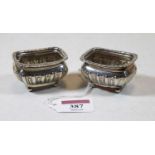 A pair of George V silver open salts, of rectangular half-gadrooned form and on ball feet, 1.7oz