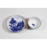 An 18th century Worcester blue and white tea bowl and saucer, decorated with figures before a pagoda