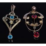 An Edwardian 9ct and garnet set openwork pendant, 36mm; together with one other blue topaz set