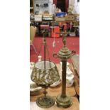 A brass twin light table lamp, surmounted by a Greek style twin handled urn, on a fluted column