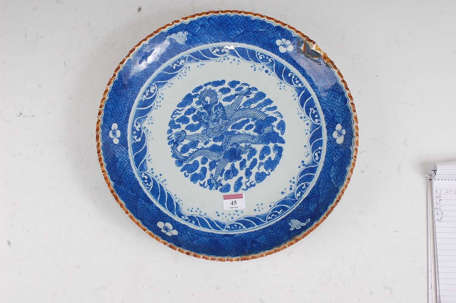 A large Chinese stoneware blue & white charger the centre glazed with a dragon amidst clouds - Image 2 of 9