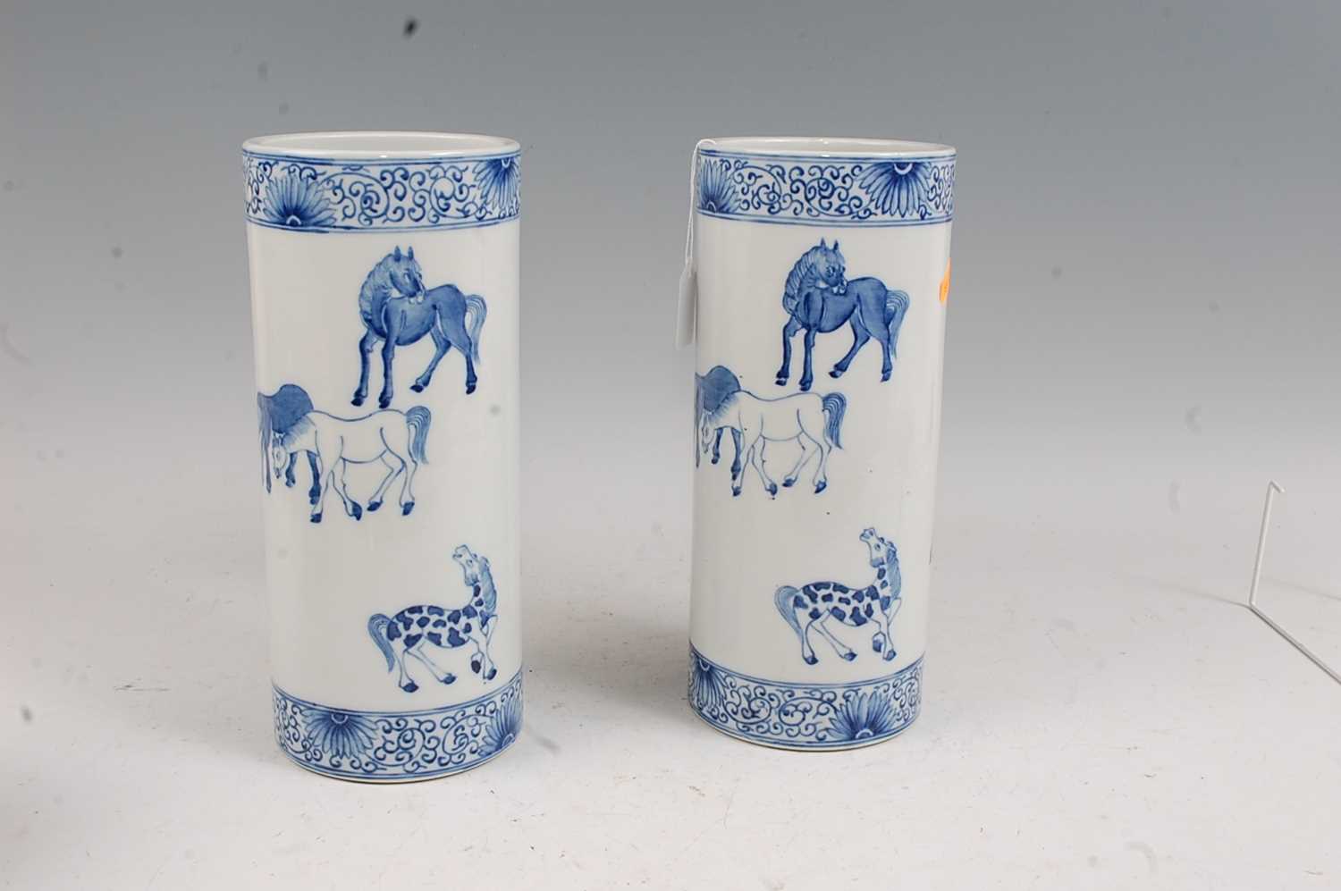 A pair of Chinese blue & white vases each of cylindrical form decorated with various horses within - Image 3 of 5