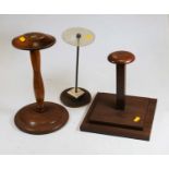 A 20th century turned oak wig stand, 31cm high, together with two other wig stands