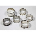 Six various silver napkin rings, Edwardian and later, five being pierced cylindrical examples,