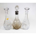 A pressed glass decanter with a metal collar H34cm, together with two similar decanters (3)