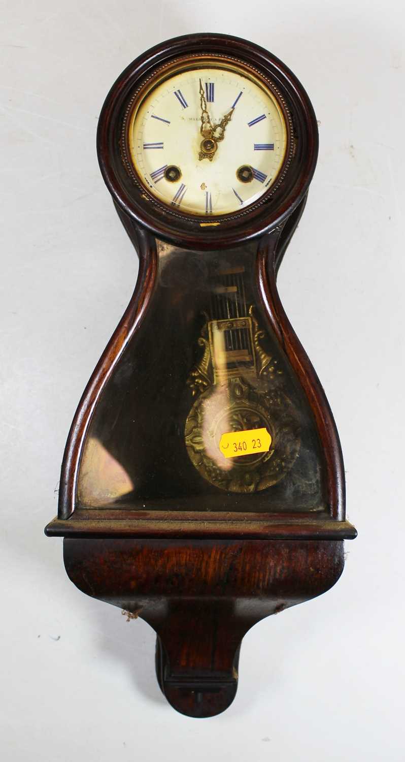 Malecot of Paris, a faux rosewood cased balloon shaped bracket clock having signed white enamel