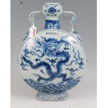 A Chinese export blue & white moon flask of slab sided circular form underglaze blue and white