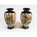 A pair of 20th century Japanese Satsuma vases, of ovoid form, decorated with figures before a