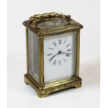 A mid-20th century lacquered brass cased carriage clock, having an enamelled dial with Roman
